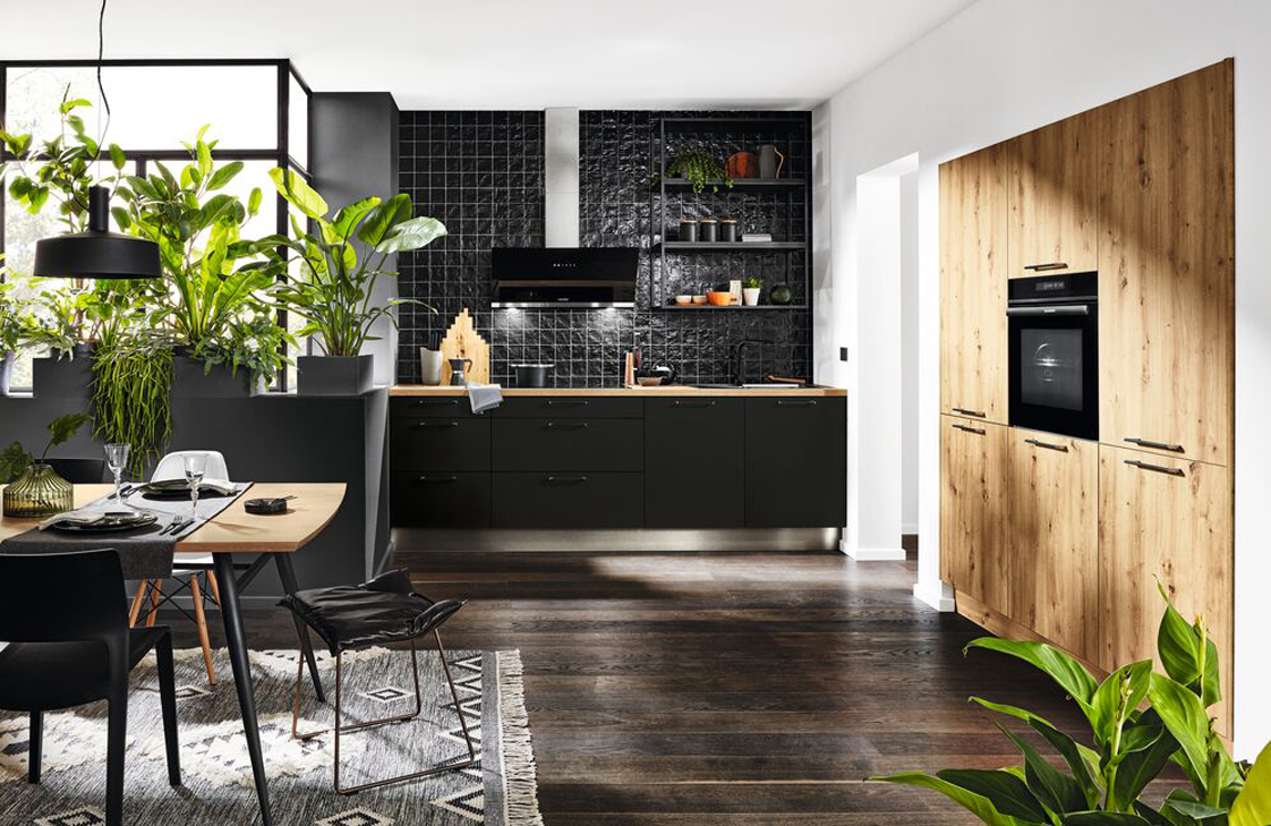 Design zwarte keuken met greep gecombineerd met een houten kastenwand