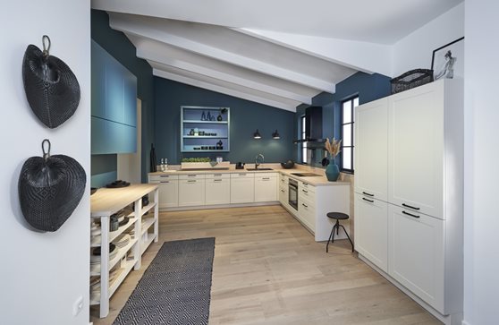 Landelijke lichte keuken met kaderdeur en greep gecombineerd met blauwe kastjes